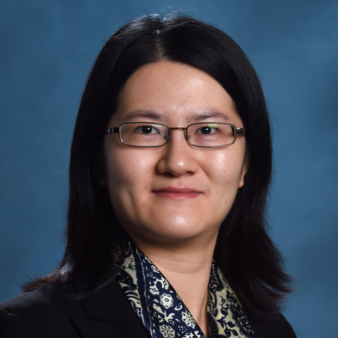 UIC MPA Associate Professor Jiaqi Liang smiles in glasses