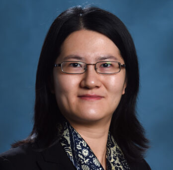 UIC MPA Associate Professor Jiaqi Liang smiles in glasses 