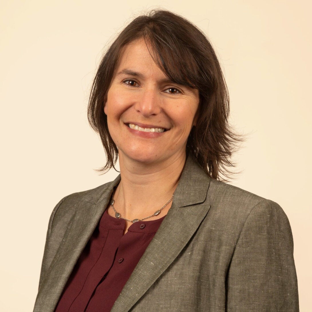 UIC Assistant Professor Dr. Kate Albrecht smiles at camera in burgundy blouse