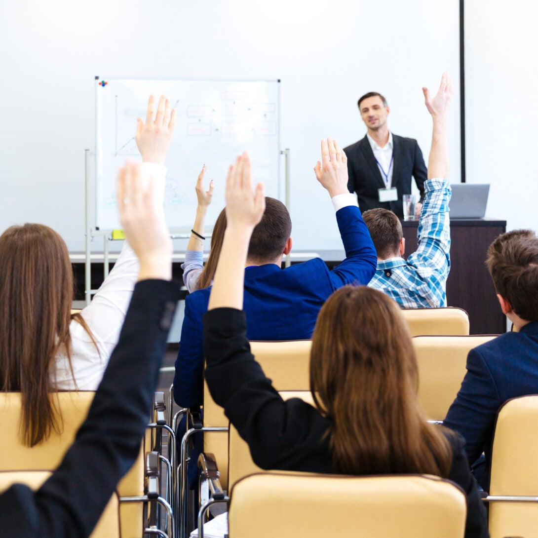 Professional with MPA degree makes a presentation in front of coworkers