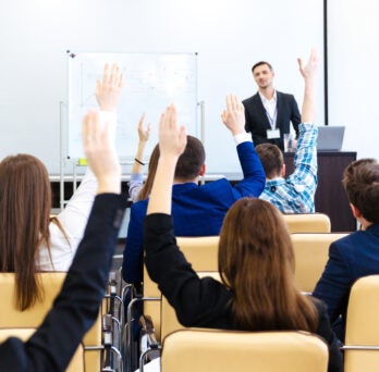 Professional with MPA degree makes a presentation in front of coworkers 